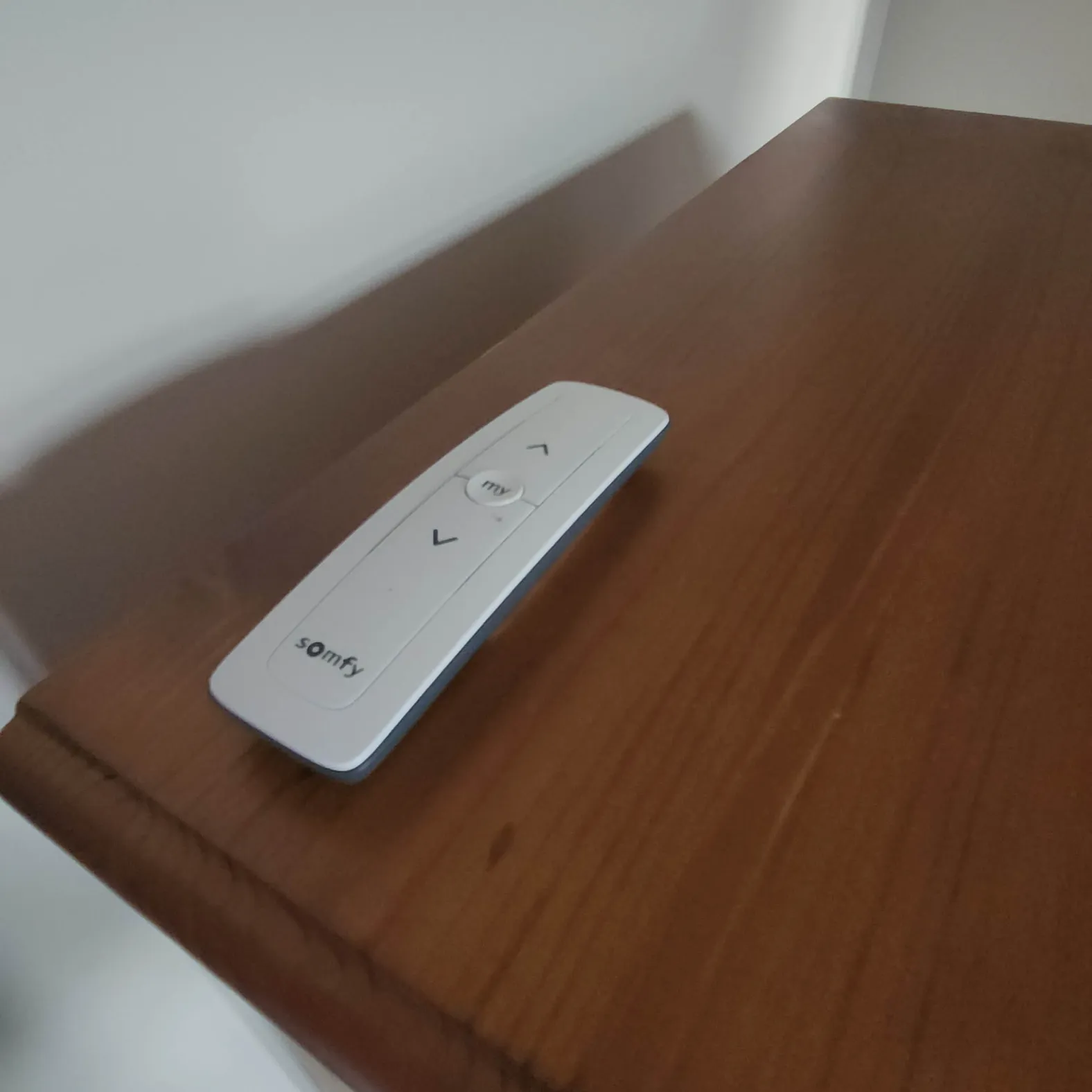Somfy remote control used for smart blinds and curtain automation in a connected home by The Real Smart Home.